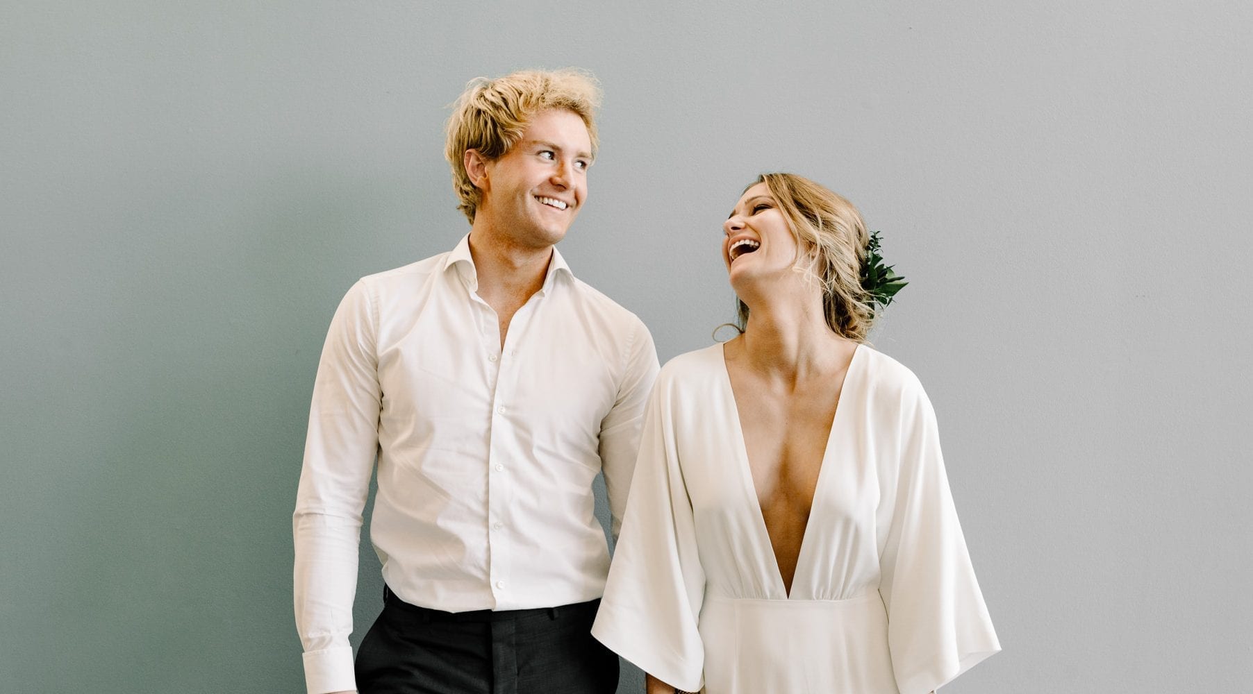 Happy and laughing wedding couple with style