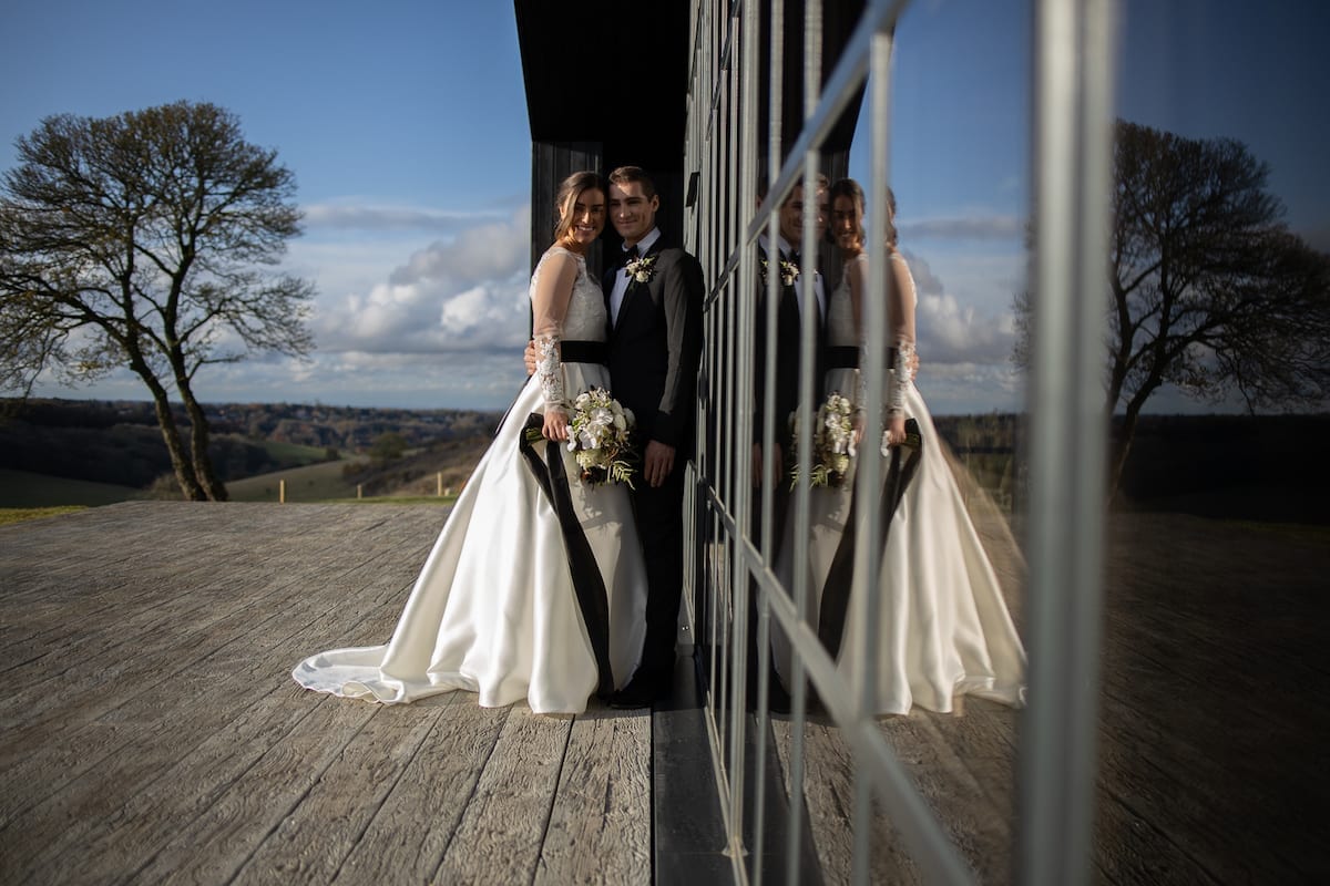 Wedding couple with reflection in window