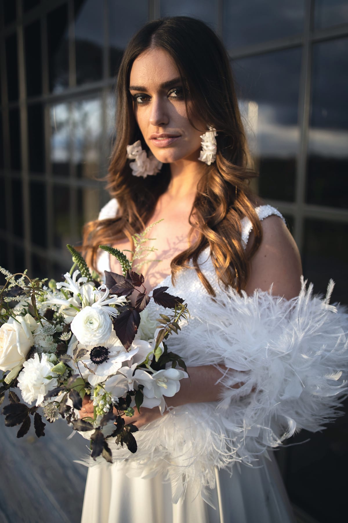 Close up of bride with feather boa and bouquet