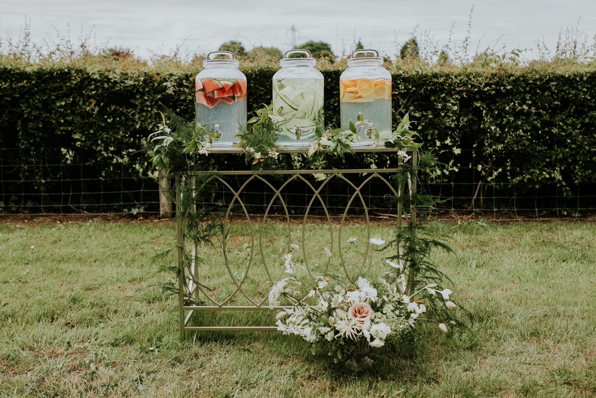 Trio of water dispensers on display for garden wedding