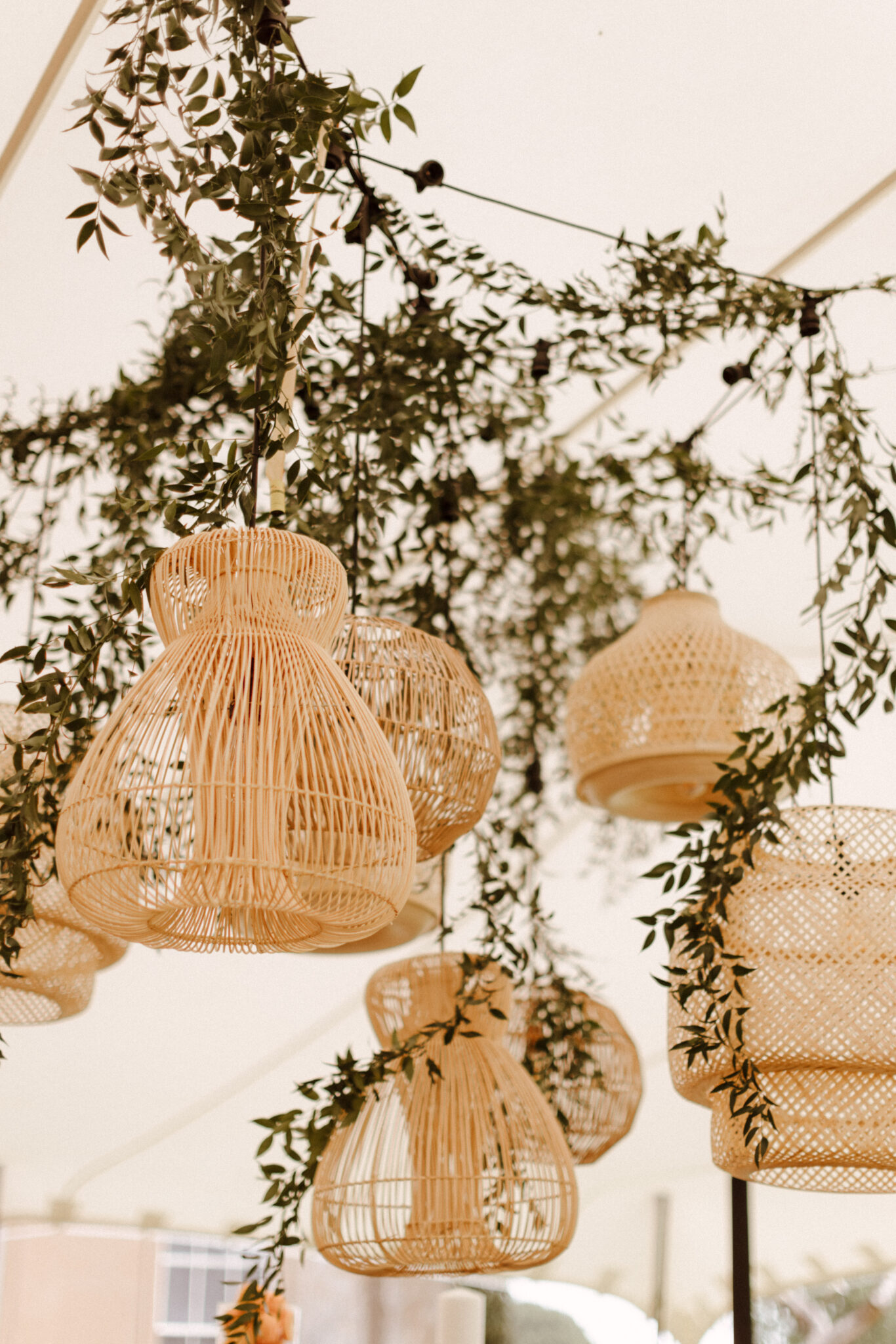 Rattan hanging lanterns with greenery entwined