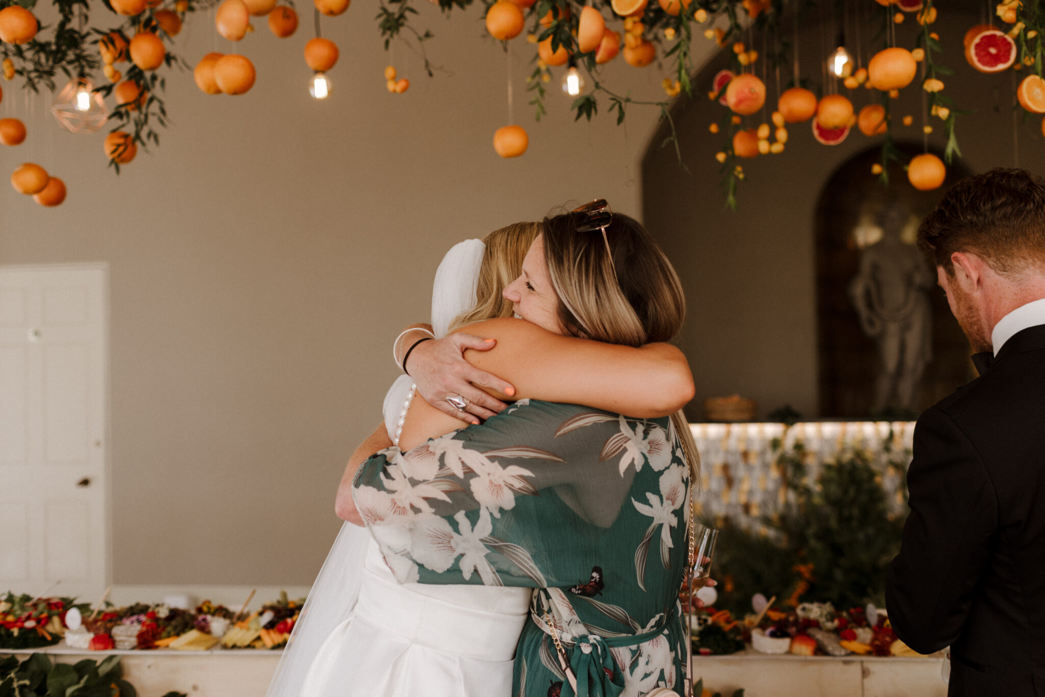 Bride and wedding planner embracing