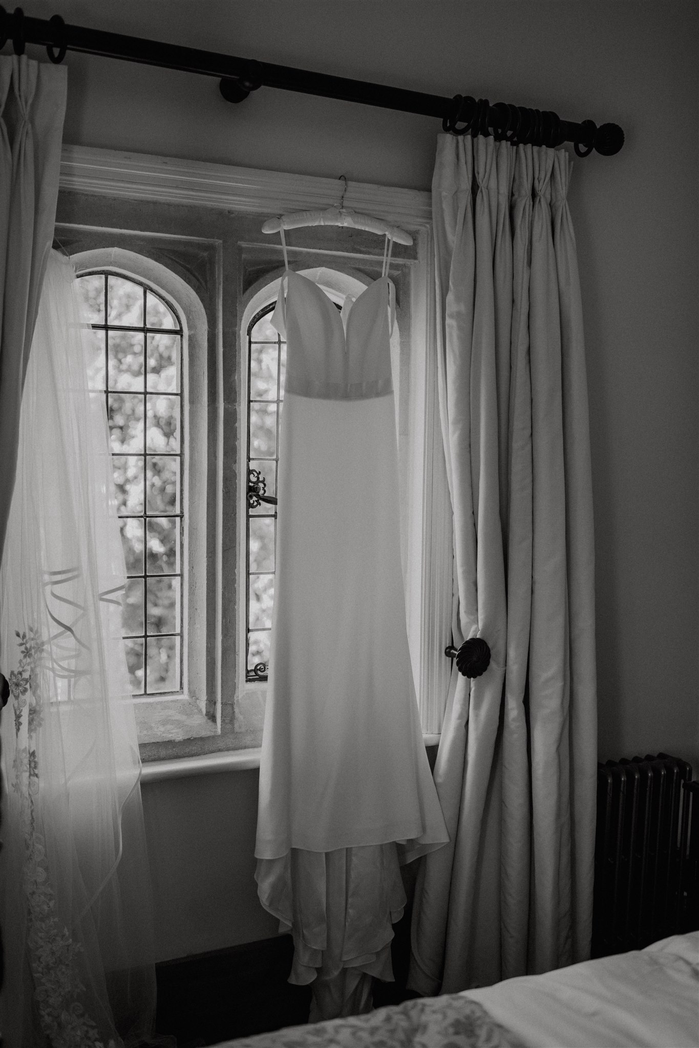 Wedding dress hanging in window